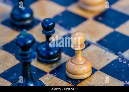 Holz- Schach Bauer gelber Farbe auf einem karierten Brett grunge Stockfoto