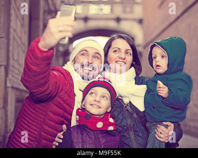 Positive Familie von vier Tun selfie in Stadt in Winter Tag Stockfoto