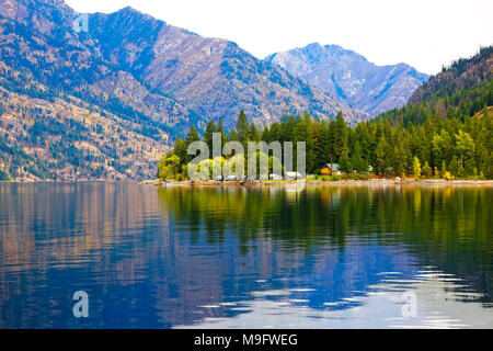 41,926.03703 Lake Chelan Wald Halbinsel Berge fallen Blätter im Herbst Nadelbäumen im Wasser widerspiegelt, Lake Chelan Boating Club, Luzern, WA USA Stockfoto