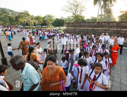 Schüler und Lehrer in einer Warteschlange außerhalb der Tempel des Zahns, Kandy, Sri Lanka, Asien. Stockfoto