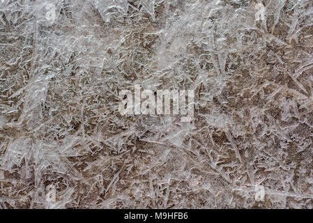 Textur von gefrorenem Eis, unter denen es ist Sand. Stockfoto