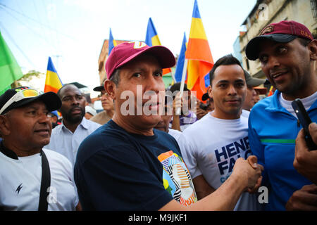 26 März 2018, Venezuela, Caracas: Kandidat der Opposition Henri Falcon (C) Walking mit Anhänger durch die Straßen der Armenviertel von Petare. Der ehemalige Gouverneur brach der Boykott, der von den wichtigsten Opposition Koalition, Schlamm, und Angemeldet als Präsidentschaftskandidaten. Maduro sucht für eine Amtszeit endet im Jahr 2025 während der kommenden Wahlen vom 20. Mai wiedergewählt werden. Beobachter befürchten, dass die Wahlen weder frei noch fair. Foto: Wil Riera/dpa Stockfoto