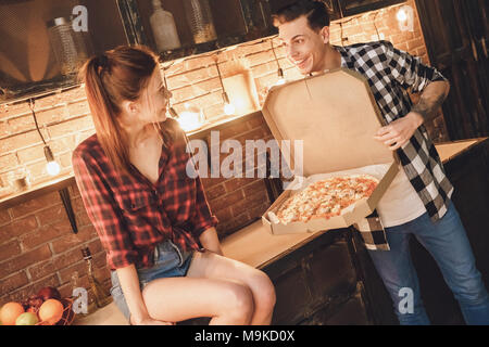 Mann big Pizza kaufen. Frau shoked. Hallenbad, Küche Home Interior, Studio gedreht. Stockfoto