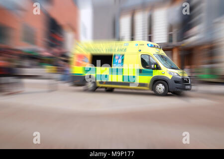 NHS Krankenwagen mit blauen Lichtern in der Stadt Großbritannien Stockfoto