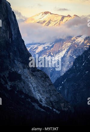 Sonnenuntergang Upvalley - nach Osten, vorbei an El Capitan als das letzte Licht des Sonnenuntergangs Hits der Gipfel von Wolken Rest Stockfoto