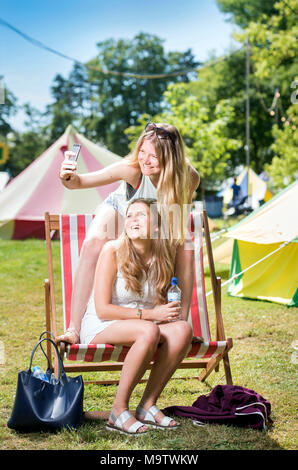 Mädchen nehmen eine selfie in einem "Glamping" Bereich am Cornbury Music Festival de Stockfoto