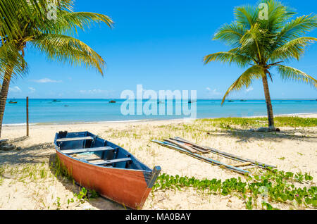 Rot und blau Kanu ausgestreckt auf der Sand am Strand. Hintergrund Mit der klare Himmel an einem sonnigen Tag und einen schönen blauen Meer. Stockfoto