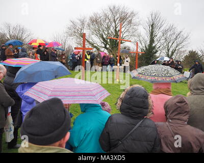 Münster am Meer, Kent, Großbritannien. 30. März, 2018. Karfreitag Zeremonie: Kirchen gemeinsam in Sheppey (CTiS) jährlichen Karfreitagsprozession des Zeugnisses. Drei Holzkreuze wurden von Sheerness, Eastchurch und auf halbem Weg zu einer Zeremonie im Regen an der Spitze der Glen in Münster am See, einer der höchsten Punkte der Insel Sheppey. Der einfache Dienst ist für alle Stückelungen von Kirchen gemeinsam organisiert in Sheppey (CTiS) und auf die grünen Hügel der Insel mit mehr als 35 Jahren statt. Credit: James Bell/Alamy leben Nachrichten Stockfoto