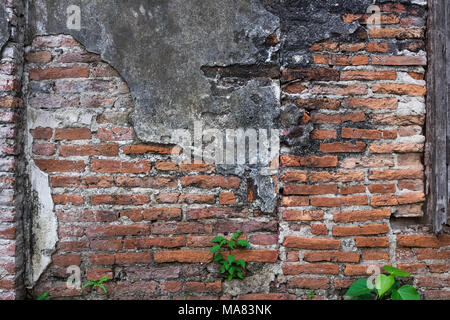 Risse und die Verfallenen brick Stuck Wand Textur Hintergrund Verwitterten vor langer Zeit. Stockfoto