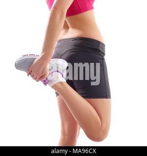 Junge Frau stretching quad Muskeln, Studio gedreht. Stockfoto