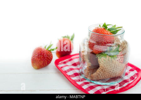 Frische Erdbeeren im Glas auf weißem Holz Hintergrund mit selektiven Fokus Stockfoto