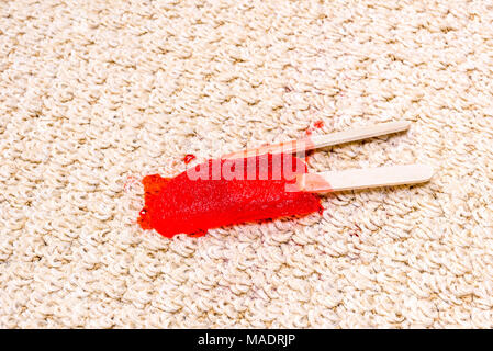 Einem Time Lapse-Videorecorder eines schmelzenden Popsicle auf weißen Teppich zeigt die eisigen behandeln in einem klebrigen Saft schmelzen und rechts in den Teppich zu absorbieren. Stockfoto