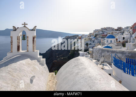 Ein Glockenturm der Kirche mit Blick auf Oia auf Santorini. Stockfoto