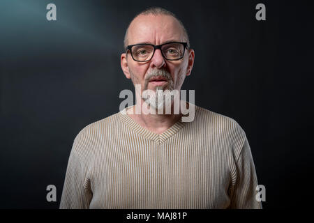 Porträt von einem alten Mann mit grauem Bart und Brille Stockfoto