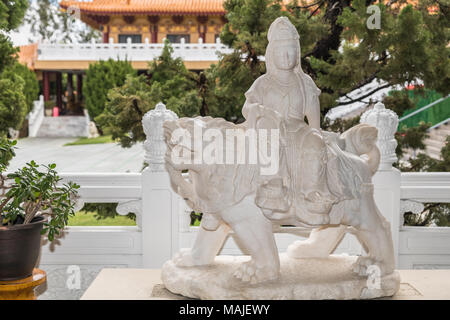 Hacienda Heights, CA, USA - 23. März 2018: Die weiße Statue des Avalokitesvara Bothisattva, Guanyin, Gebet, Perlen und sitzen auf Lion an der Seite des Stockfoto