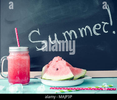 Sommer auf der Tafel mit Wassermelone Saft im Glas Marmeladenglas mit Scheiben von Wassermelone und Eis auf blauem Hintergrund geschrieben. Frisches Obst aromatisierte c Stockfoto