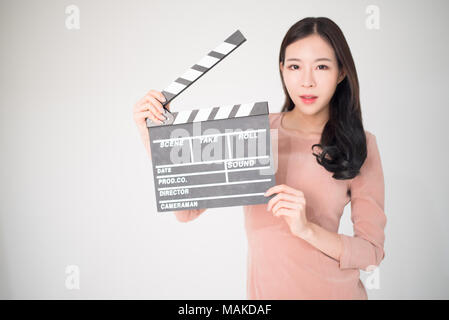 Sian Frau mit filmklappe Board auf weißem Hintergrund. Kinematografie, Kommunikation, Kultur, Casting, Audition, Film Produktion Konzept. Stockfoto