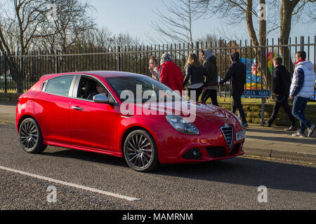 Red Alfa Romeo Giulietta 2,0 JTDM-2 Speciale bei der North-West Supercar Veranstaltung als Autos und Touristen im Küstenort ankommen. Die Autos sind an der Strandpromenade von der Stange, da Liebhaber klassischer und italienischer Sportwagen das warme Wetter für einen Tag im Auto nutzen. Stockfoto