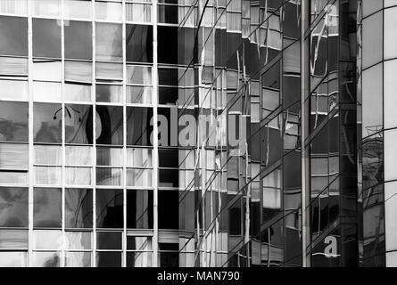 Detail der Fassade aus Glas mit Reflexionen in Schwarz und Weiß Stockfoto