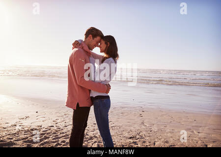 Romantisches Paar am Strand entlang Winter zusammen gehen Stockfoto