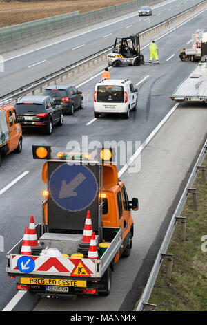 Abschleppwagen Arbeitnehmer Reinigung Wreckage von Verkehrsunfall auf Landstraße, Notdienste Antwort Stockfoto