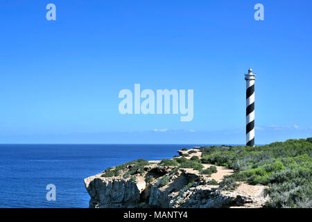 Rundumleuchte oder gestreifte Leuchtturm auf der Insel Ibiza. Schwarze und weiße Leuchtturm auf einer Klippe Küste oder die Küste. Stockfoto