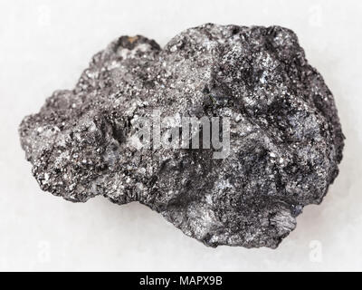 Makroaufnahmen von natürlichen Mineralgestein Muster - Rohstoff Graphit Stein auf weißem Hintergrund aus Bogotol region Ostsajan-gebirge, Russland Stockfoto