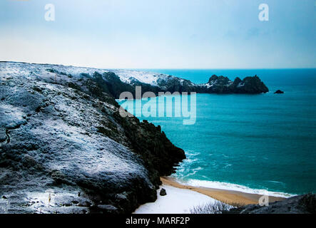 Schnee fällt auf Porthcurno Küste in Cornwall, England Stockfoto