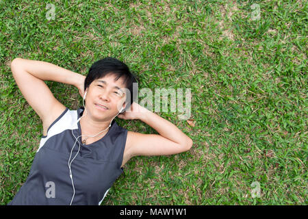 Ältere Frau auf dem Gras Stockfoto