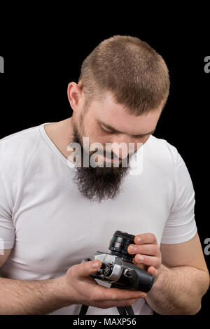Mann hipster, Holding a vintage Kamera in den Händen. Stockfoto