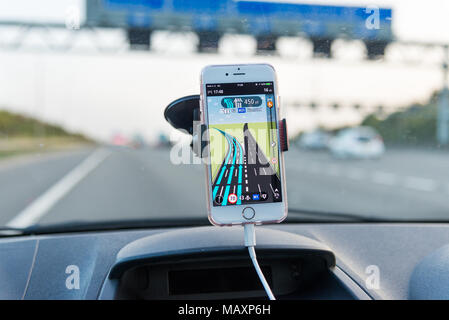 Über TomTom Navi App auf das iPhone während der Fahrt auf der Autobahn M25, Großbritannien Stockfoto