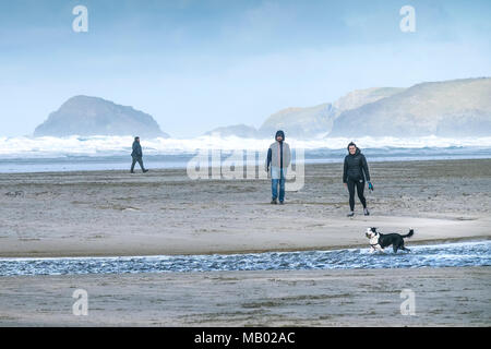 Leute, die ihren Hund am Strand in Perranporth Cornwall. Stockfoto