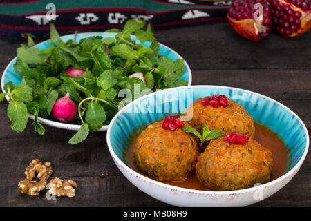 Koofteh Tabrizi große Frikadellen gefüllt mit getrockneten Früchten, Beeren und Nüsse in Tomaten Kurkuma Brühe eine traditionelle aserbaidschanische und iranischen Gericht serviert In Tu Stockfoto