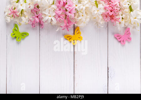 Frühling Hintergrund mit bunten Schmetterlingen, Hyazinthen Blumen auf weißem Holzbrett mit Kopie Raum Stockfoto