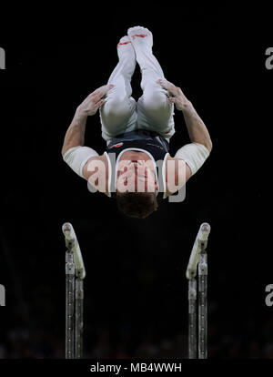 England's Nil Wilson auf dem Barren auf seinem Weg zum Gewinn einer Goldmedaille bei den Herren Individuelle all-round Finale mit Trainer Ben Collie an der Coomera Sporthalle am Tag drei der Commonwealth Games 2018 in der Gold Coast, Australien. Stockfoto