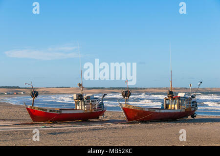 Zwei rote Fischerboote liegen am Strand des Atlantischen Ozeans, Dorf Cabo Polonio, Cabo Polonio Nationalpark, Provinz Rocha Stockfoto