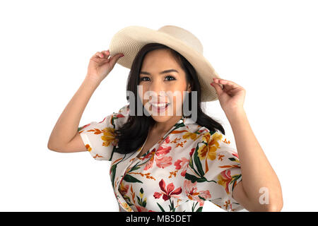 Die Hälfte geschossen Foto der hübschen Mädchen mit geblümten Kleid mit weißen Strohhut auf dem Kopf im Studio. Stockfoto