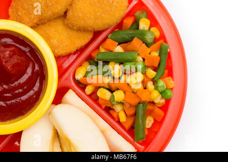 Kinder- Platte mit einer gut ausgewogenen Mahlzeit von Chicken Nuggets, Gemüse in Scheiben geschnitten und Apple Stockfoto