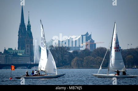 08 April 2018, Deutschland, Hamburg: Segelboote auf der Außenalster bei sonnigem Wetter. Die Elbphilharmonie kann im Hintergrund gesehen werden. Foto: Axel Heimken/dpa Stockfoto