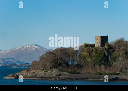 Dunstaffnage Castle & Kapelle in der Nähe von Oban an der Westküste von Schottland mit Schnee bedeckte Berge in der Ferne Stockfoto