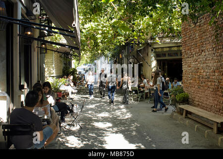 Die Menschen genießen schöne Wetter in Cafes im angesagten Stadtteil Karaköy in Istanbul. Stockfoto