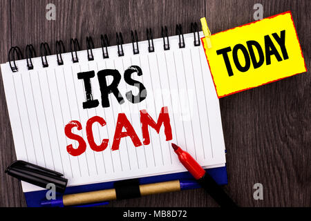 Wort schreiben Text Irs Scam. Business Konzept für Warnung Scam Betrug Steuer Pishing Spam Geld Einnahmen Alert System geschrieben Notebook Buch die hölzerne Hinterg Stockfoto