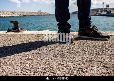Schuhe. Ein Mann in casual Schuhe auf einem Pier in der Nähe des Meeres. Stockfoto