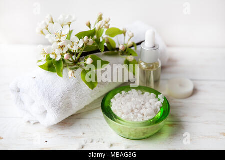 Spa mit Meersalz, Blumen und Kerzen auf wicker Fach Massage Öl, Handtuch, Meersalz und Kerzen Stockfoto