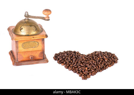 Kaffeemühle mit Kaffeebohnen in der Form eines Herzens. Stockfoto