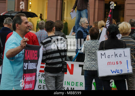 Mainz, Deutschland. 9. April 2018. Ein rechter Demonstrant hält ein Schild mit der Aufschrift 'MErkel hat zu gehen'. Rund 50 Rechtsextreme Demonstranten in der Innenstadt von Mainz sammelte, gegen die deutsche Regierung zu protestieren, für die Schließung der Grenzen und gegen Flüchtlinge unter dem Motto goÕ ÔMerkel hat. Sie wurden von rund 400 Zähler Gehechelt-Demonstranten. Quelle: Michael Debets/Alamy leben Nachrichten Stockfoto