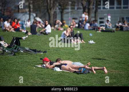 10 April 2018, Deutschland, Berlin: Menschen genießen Sie die Sonne auf der Wiese gegenüber der Museumsinsel. Foto: Arne Bänsch/dpa Stockfoto