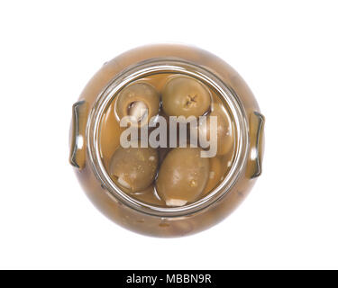 Grüne kolossale Oliven gefüllt mit Knoblauch Handschuhe Hand in den jar Stockfoto