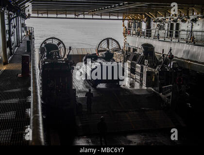 Ozean (Feb. 14, 2018) Marines bis 26 Marine Expeditionary Unit Bataillon Landung Team zugewiesenen direkt ein amphibisches Fahrzeug in das Deck des Dock Landung Schiff USS Oak Hill (LSD 51). Die Iwo Jima Amphibious Ready Gruppe begibt sich die 26 MEU und umfasst Oak Hill, die Amphibisches Schiff USS Iwo Jima (LHD7), die amphibious Transport dock Schiff USS New York (LPD 21), Flotte Op-Team 8, Hubschrauber Meer Combat Squadron 28, Tactical Air Control Squadron 22, Komponenten der Naval Beach Gruppe 2 und die begonnen, Mitarbeiter der Amphibischen Squadron 4. (U.S. Marine Stockfoto