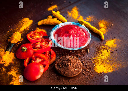 Nahaufnahme von Tomatenmark, Sandelholz, Kurkuma und seine Pulver auf einer hölzernen Oberfläche. Sie wird verwendet, um die dunklen Köpfe und schwarze Haut zu löschen. Stockfoto